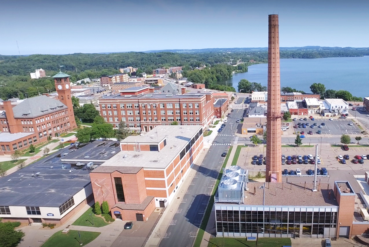 A wide photogram of the central heating plant taken with a drone showing the main chimney and surrounding campus.
